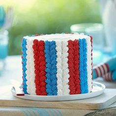 a red, white and blue cake sitting on top of a table