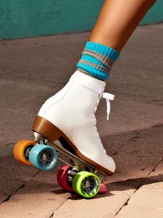 a person riding a skateboard with colorful wheels