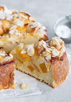 a cake that has been cut into pieces and is sitting on a table with powdered sugar