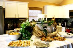 a kitchen filled with lots of food on top of a table