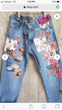 a pair of jeans with patches and flowers on them