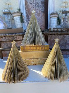 three folded paper trees sitting on top of a table