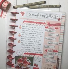 a recipe book with strawberries and cupcakes on it next to some markers