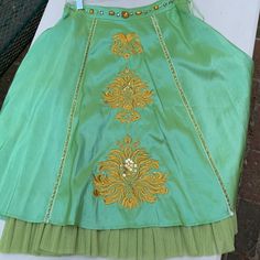 Sugar Lips, Gorgeous Iridescent Apple Green Skirt With Golden Embroidery & Sequins L Up Front, Gems Along Waist & Along Front Panel, A-Line Cut, Hidden Side Zipper, Peekaboo “Crinoline” Bottom Accent, Never Worn, Catches Light To Shimmer, Fully Lined, Stunning And Unique, Perfect For Cocktails, Art Opening, Summer Outdoor Event, Dinner Date, Semi Formal, Unique, Boho, Artsy, Shimmer, Sophisticated, Eye Catching, Fun! Waist 14.5” Measured Flat. Festive Embellished Long Skirt, Traditional Embellished Long Skirt, Traditional Embellished Festive Skirt, Traditional Long Embellished Skirt, Green Embellished Party Skirt, Traditional Embellished Skirt For Festive Occasions, Traditional Green Embroidered Skirt, Festive Fitted Green Skirt, Elegant Green Festive Skirt