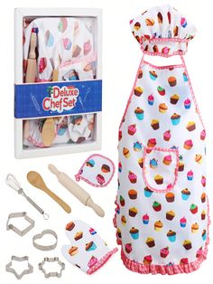 the doll is wearing an apron with cupcakes on it and baking utensils