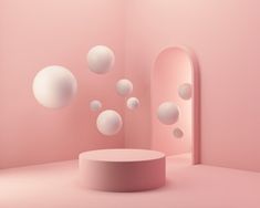 a pink room with white balls floating in the air and a round table on the floor