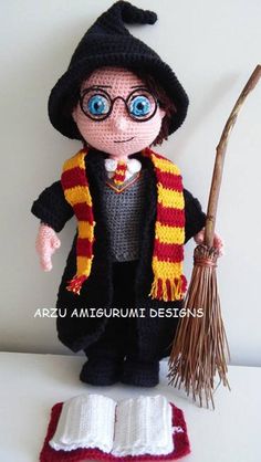 a crocheted harry potter doll holding a broom