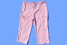 Mid rise baby pink cargo capri pants. Adjustable waist. Functional zipper pocket on each leg. 59% Polyester, 49% Nylon. Size LARGE, 35 inches waist, 32.5 inches length. Casual Pink Capris, Pink Stretch Cargo Pants For Spring, Spring Pink Stretch Cargo Pants, Sporty Pink Cargo Pants For Spring, Stretch Pink Cargo Pants With Cargo Pockets, Pink Stretch Cargo Bottoms, Stretch Pink Cargo Pants With Pockets, Pink Stretch Cargo Pants With Cargo Pockets, Stretch Pink Bottoms With Cargo Pockets