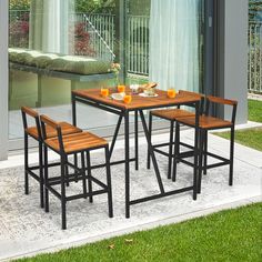 an outdoor table and chairs set up outside