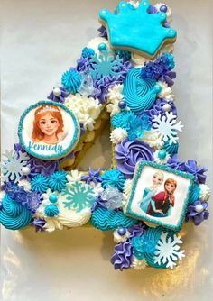 the number four cake is decorated with frozen princesses and snowflakes