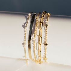 This stunning piece features lustrous pearls, elegantly stationed on a delicate chain. Add a touch of luxury to any outfit and feel confident and chic wherever you go. Elevate your style with the Meg Station Bracelet. *Also available in SILVER PRODUCT DETAILS Size: 6.5" + 1.25" extension Metal: 18k Gold Plated Brass Material: Imitation Pearls The Meg, Station Bracelet, Delicate Chain, Bracelet Gold, Brass Material, Charm Earrings, Feel Confident, Anklets, Gold Bracelet