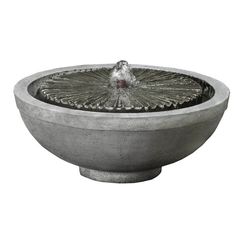 a concrete bowl with a bird on it's head and water feature in the center