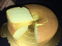 a cake that has been cut in half and is on a gold platter with one slice taken out