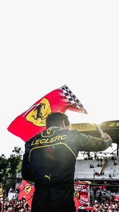 a man holding a flag in front of a crowd