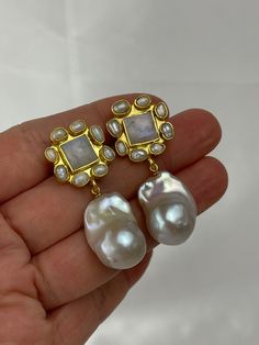 Indulge in the allure of natural beauty with our handcrafted gemstone and pearl earrings. Each earring features a stunning square-cut gemstone, available in mesmerizing moonstone, refreshing chrysoprase, or mystical labradorite. Encircled by delicate genuine rice pearls and embraced by a 22k gold-plated brass bezel, these earrings exude elegance and sophistication.Dangling gracefully beneath, a lustrous baroque pearl steals the spotlight. Crafted from high-quality cultured pearls, each pair boasts a magnificent 15mm x 20mm size (approximate). However, please note that the size and shape of the baroque pearls may vary, as nature gifts each pearl with its unique characteristics. Rest assured, the pearls you receive will mirror the exquisite quality showcased in our photos, albeit with slight Unique Wedding Earrings, Unique Pearl Earrings, Baroque Earrings, Earring Bridal, Bridal Statement Earrings, Heart Throb, Rice Pearls, Baroque Pearl Earrings, Statement Earring