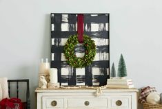 a christmas wreath on top of a dresser