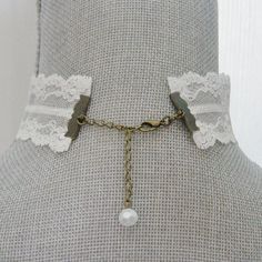 "This lovely white choker necklace is made up in a white floral pattern vintage lace. The choker closes at 13\" there is an extension chain for adjustable sizing. The antique brass chain extension has a dangle white crystal bead accent. There is an antique gold lobster claw closure for adjustable fit on the chain links. This lace choker is made up with antique gold accents. All of my jewelry items come boxed and lace ribbon tied and tagged for easy gifting." Vintage White Choker For Gift, White Adjustable Choker Necklace, White Lace Necklace For Wedding, Vintage White Handmade Choker, Lace Trim Choker Jewelry Gift, Lace Choker Jewelry Gift, Lace Choker Jewelry For Gifts, Lace Choker Jewelry As Gift, Adjustable Cream Choker