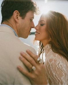 a man and woman kissing each other with the sun shining through their windows behind them