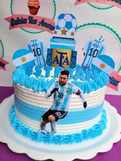 a soccer player on top of a cake with blue icing and white frosting