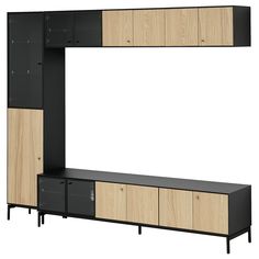 an entertainment center with wooden cabinets and black doors