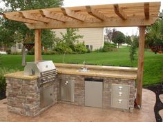 an outdoor kitchen with grill and sink