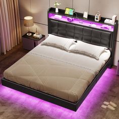 a bed that has some lights on the headboard and foot board in front of it