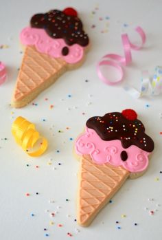 three ice cream cones decorated with sprinkles and candy