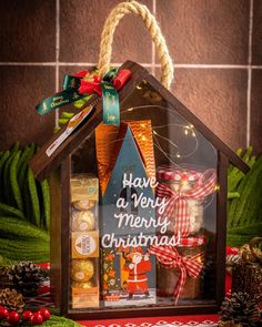 a house shaped gift box filled with christmas treats