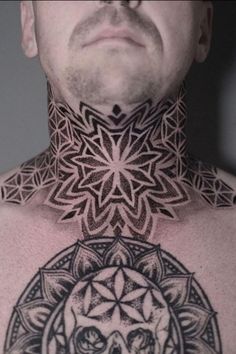 a man's neck with an intricate tattoo design on the top and bottom part