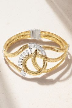 Nikos Koulis won the Couture Design Awards in the Gold category for his 2019 'Feelings' collection – the jeweler has since become a judge of the prestigious competition. This bracelet is crafted using an 18-karat gold snake chain to convey a sense of fluidity and encrusted with baguette and round-cut diamonds in contrasting white gold bezel settings. Luxury Flexible Yellow Gold Diamond Bracelet, Luxury Baguette Diamond Bracelets, Luxury Bracelets With Baguette Diamonds, Luxury Flexible Gold Bracelet For Formal Occasions, Designer Gold Jewelry With Baguette Diamonds, Luxury Baguette Diamond Bangle Jewelry, Luxury Evening Bracelets With Baguette Diamonds, Luxury Baguette Diamond Bangle, Luxury Yellow Gold Jewelry With Baguette Diamonds