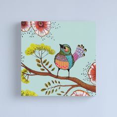 a colorful bird sitting on top of a tree branch with flowers in the background canvas print