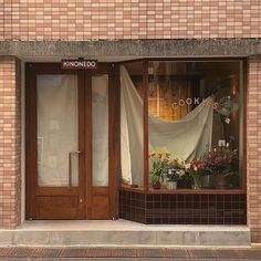 a store front with flowers in the window