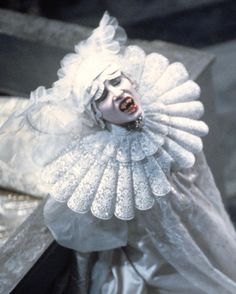 a woman with white hair and makeup in a costume