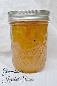 a glass jar filled with orange colored liquid