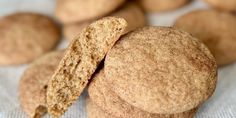 some cookies that have been cut in half and are on a white surface with other cookies behind them