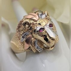 This Is A Very Cool Lions Head Ring! Crafted In 10k Yellow, Rose, And White Gold, There Is Wonderful Detail To The Face. The Eyes Are Synthetic Rubies And There Are Bright Cz's Along The Mane, As Well As A Large Cz Stone Held In The Jaws. Size 10-1/2 Measures Just Over 3/4" N-S (Approximately 21 Mm). 10.7 Grams **This Will Go Through The Poshmark Authentication Process.** *Please Ask Any Questions By Commenting Below. *I Generally Ship Within 24 Hours But Please Reach Out If You Need To Ensure E Lions Head, Lion Ring, Gold Lion, Head Ring, Mens Accessories Jewelry, Ring Color, Cz Stone, Yellow Rose, 10k Gold