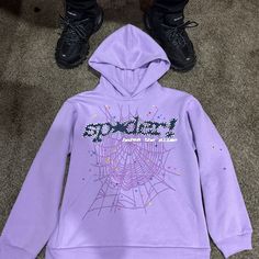 Purple Black And White Spider Hoodie With Stars Going Through Out The Hoodie Purple Hooded Cotton Outerwear, Hooded Purple Cotton Outerwear, Purple Hooded Sweatshirt With Drawstring, Purple Hoodie With Double-lined Hood And Long Sleeves, Purple Letter Print Sweatshirt For Streetwear, Purple Sweatshirt For Winter Streetwear, Purple Long Sleeve Hoodie With Double-lined Hood, Hooded Purple Sweatshirt For Streetwear, Purple Hooded Sweatshirt For Streetwear