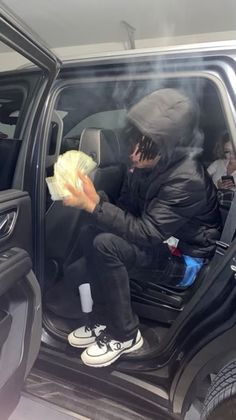 a man sitting in the passenger seat of a car