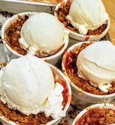 several desserts are arranged in bowls on a table