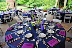 the tables are set with purple napkins and silverware for an elegant wedding reception