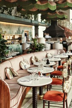 an empty restaurant with tables and chairs lined up against the wall in front of it