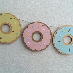 three doughnuts are hanging on a string