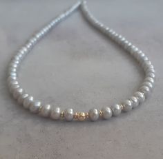 14k solid yellow gold and light gray fresh water pearl necklace/chocker. Modern up to date with a chic statement ! Easy to wear day or night this necklace is timeless ! Good quality AAA gray button pearls with 14k solid gold rondelle beads and a 14k solid gold spring ring clasp. Measures: Pearls - 5mm approx Necklace length - please select in the drop down menu. 100% solid gold hallmarked on clasp. Can be worn alone or layered with other necklaces-as a chocker or longer.. Gray Pearl Necklace For Gift, Gray Pearl Necklace For Gifts, Gray Single Strand Pearl Necklace As Gift, Gray Pearl Necklace, Pearl Necklace Gold, Grey Pearl Necklace, Natural Pearl Necklace, Gold Pearl Necklace, Natural Pearl