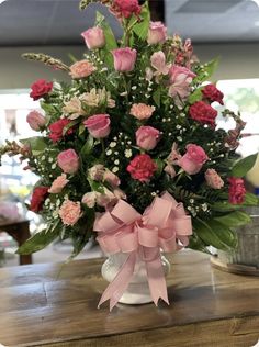 a vase filled with pink and white flowers