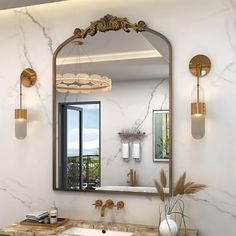 a bathroom with marble counter tops and gold fixtures on the wall, along with a large mirror