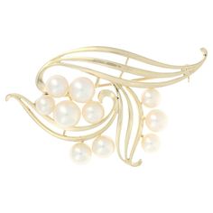 Brand: Mikimoto Metal Content: 14k Yellow Gold Stone Information Genuine Akoya Pearls Diameter Range: 5.5mm - 7.7mm Style: Brooch Fastening Type: Hinged Pin and Whale Tail Bullet Clasp Theme: Leaf Swirl Features: Open Cut Design Measurements Tall: 1 13/32" (35.0mm) Wide: 2 1/4" (56.5mm) Weight: 10.6 Grams Stamps: K14, maker's mark Condition: Pre-Owned Professionally cleaned, polished, and tested to guarantee metal content. Mikimoto Earrings, Silver Brooch Pin, Silver Jewelry Box, Sterling Silver Brooch, Pearl Brooch, Gold Stone, Akoya Pearls, Silver Brooch, Lovely Jewellery