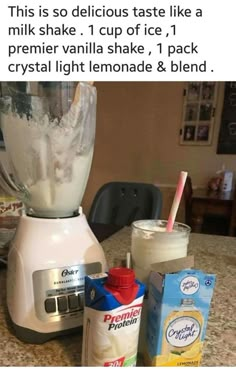 a blender sitting on top of a kitchen counter filled with milk and other items