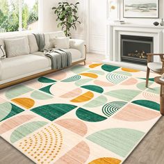 a living room with a white couch and colorful rugs on the floor in front of a fireplace