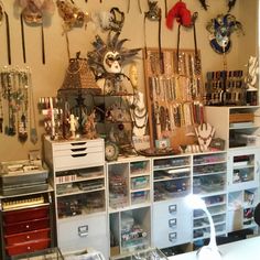 a room filled with lots of necklaces and other items on shelves next to each other