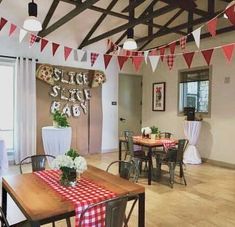 a dining room with tables and chairs decorated for a party or function, including red and white checkered tablecloths